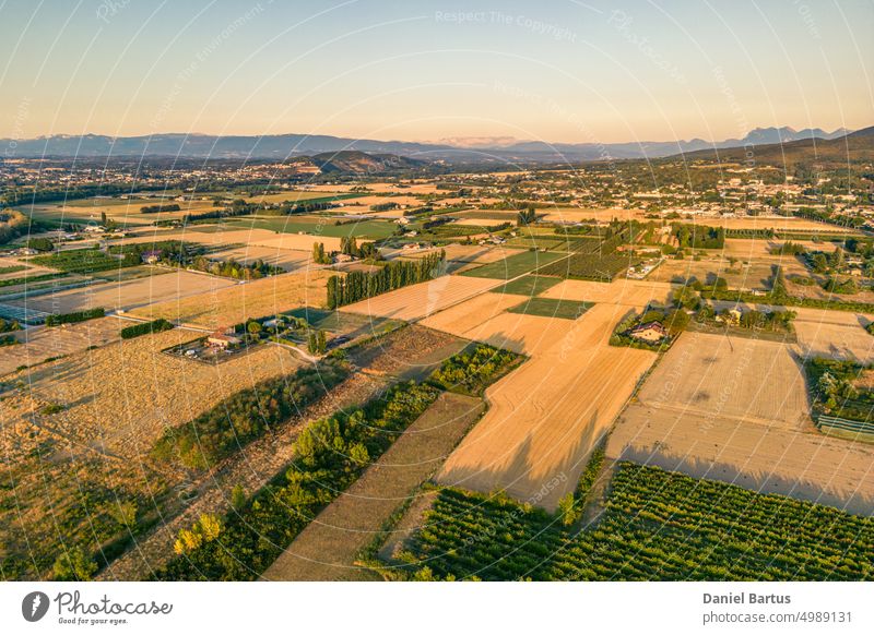 Panorama of the farmland and the mountain range during the sunset of Loriol Sur Drome - Drome - France aerial agriculture beautiful beauty countryside dawn