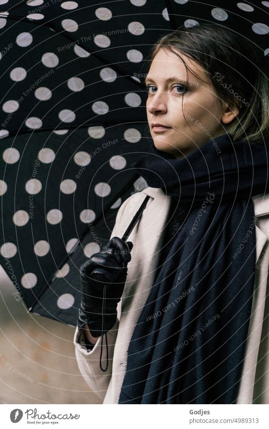 [HH Unnamed Road] Portrait of a young woman with dotted umbrella portrait Young woman Umbrella Spotted Coat Gloves Looking into the camera laterally Scarf Black