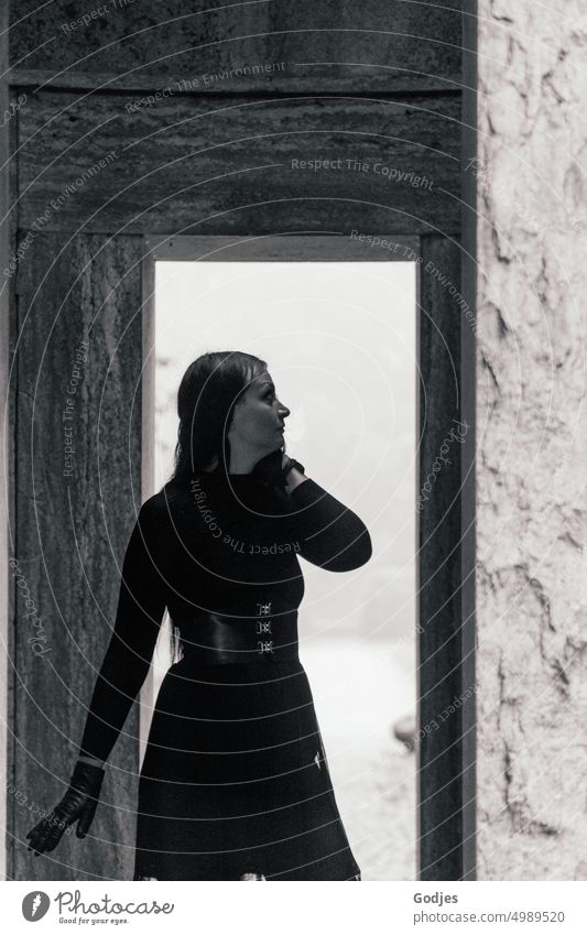 [HH Unnamed Road] posing woman in black clothing in the light of a passageway. Woman pretty youthful person Model Lady Brunette Black & white photo Elegant