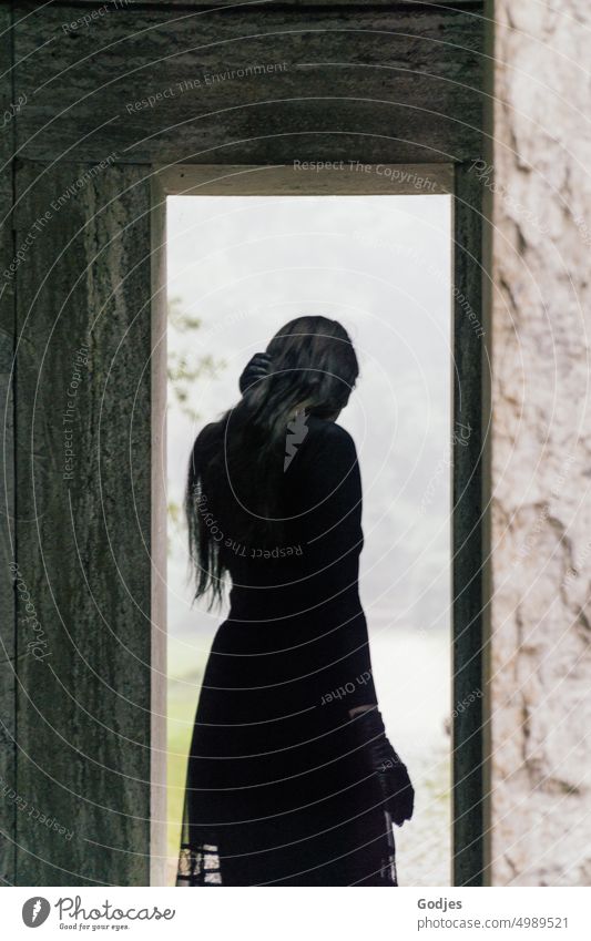[HH Unnamed Road] Rear view of a person in the light of a passageway. Woman Way out Entrance End commemoration Gothic style Black Shadow Light