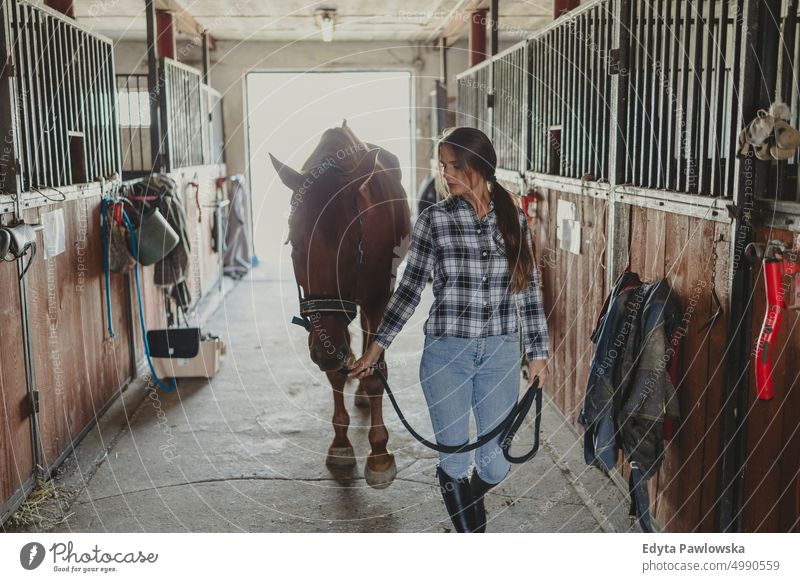 Woman with her horse in stables Horse woman Ranch Saddle Stable One Person People Adult Barn animals Rural Scene Animal Trainer care farm hobby leisure activity