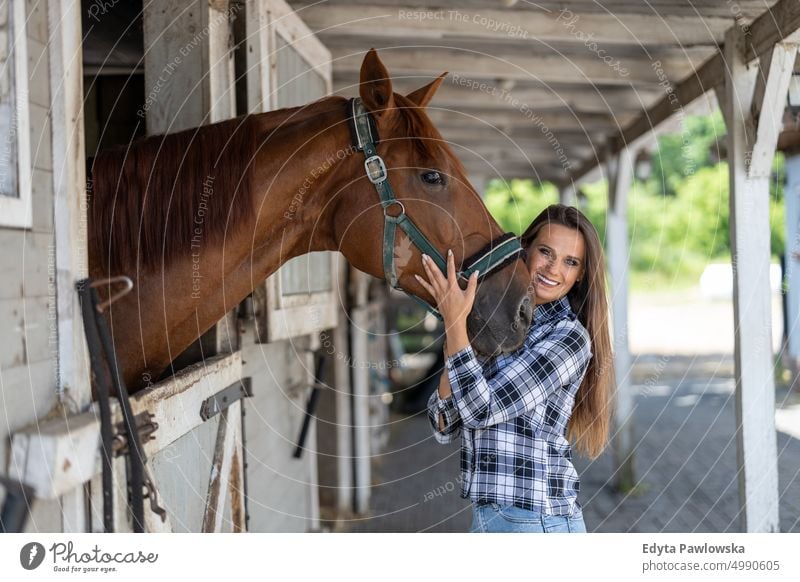 Woman with her horse in stables Horse woman Ranch Saddle Stable One Person People Adult Barn animals Rural Scene Animal Trainer care farm hobby leisure activity