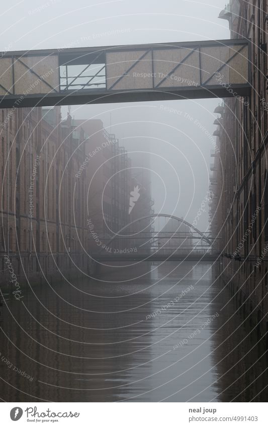 Fleet of Hamburg Speicherstadt in gray morning fog storehouse city Fog in the morning Gray Cold chill Old warehouse district Bridge Tourist Attraction