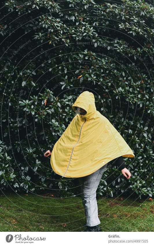[HH Unnamed Road] Woman in yellow rain jacket spins in circle in rain Rain Rotate rainy Exterior shot person single person Bad weather Weather Park green