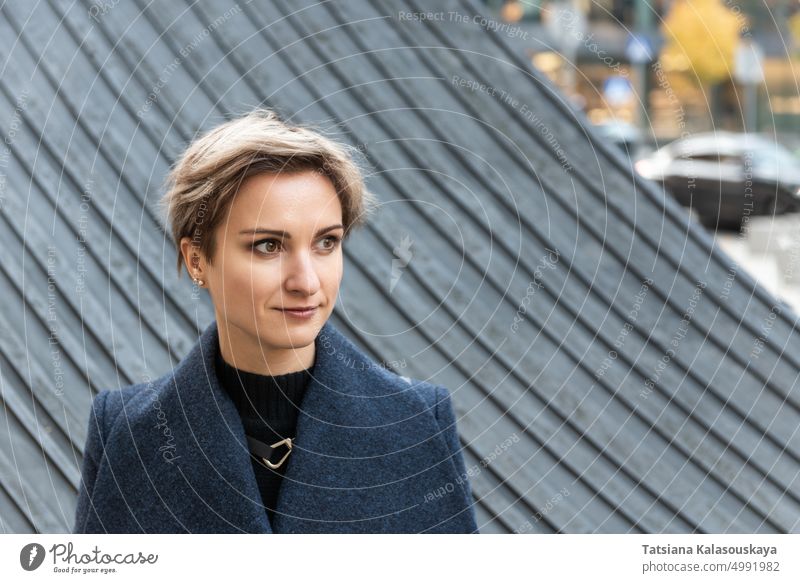 Portrait of an attractive short-haired blonde in the city in autumn woman fall chilly warm clothes Autumnal Urban Urban scene female adult Blond short hair