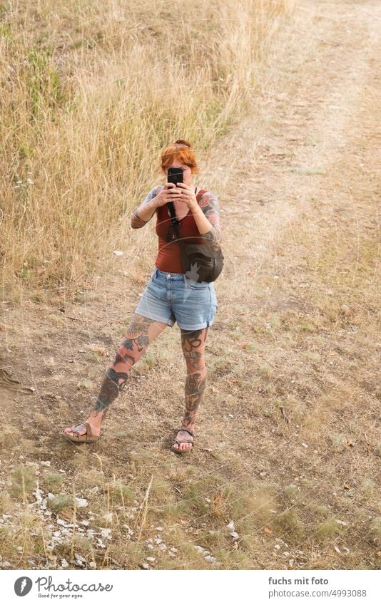 Start tattooed woman with a smartphone. Tattoo tattoos Woman Legs photo mobile phone photo portrait Cellphone tattooed girl beautiful girl pretty woman