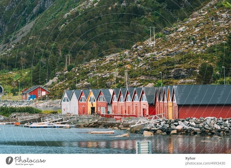 Alnes, Godoya, Norway. Red And Yellow Colorful Wooden Docks In Summer Day. Godoy Island Near Alesund Town Norwegian Nature alesund architecture beautiful berth