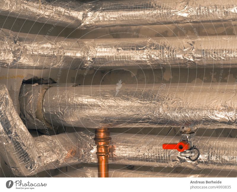 Heating pipes insulated with rock wool in a boiler room. Energy saving and energy cost reduction concept. copper pipe heat insulating installation technology