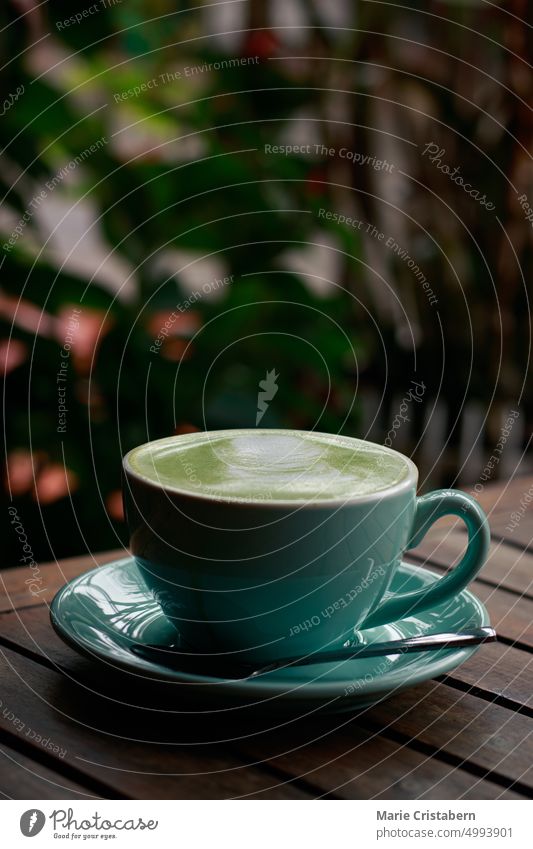 Vertical shot of a cup of matcha latte on a cold autumn day No People Cafeteria Drink Autumn Hot Drink Coffee Shop Copy Space Blue Selective Focus sweet froth