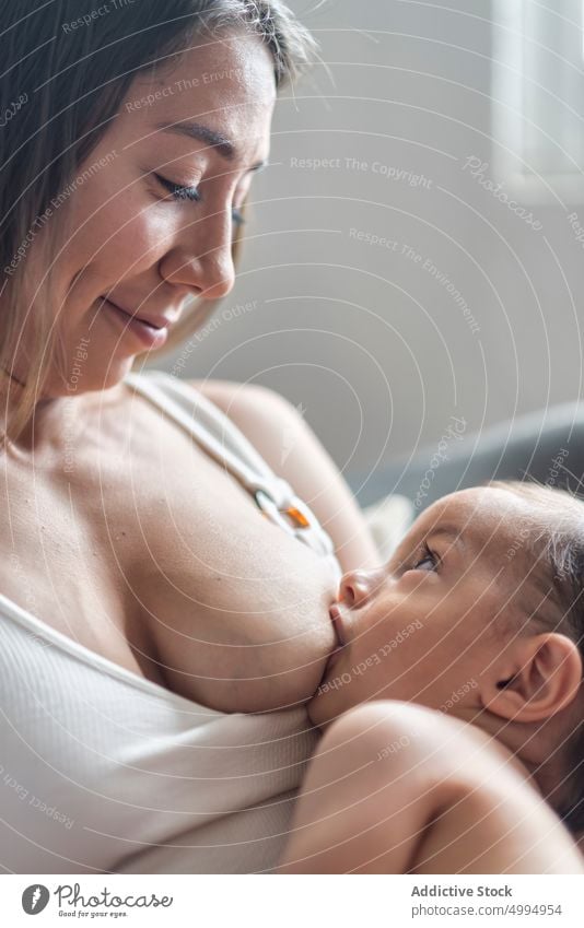 Content mom breastfeeding baby at home woman mother infant child close suck childcare motherhood childhood sweet tender adorable cute together kid little