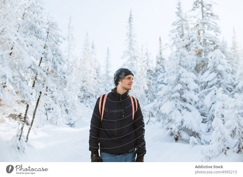 Young man in snowy forest in winter tourist spruce nature explore cold outerwear valley of the ghosts monts valin quebec canada national park traveler tourism