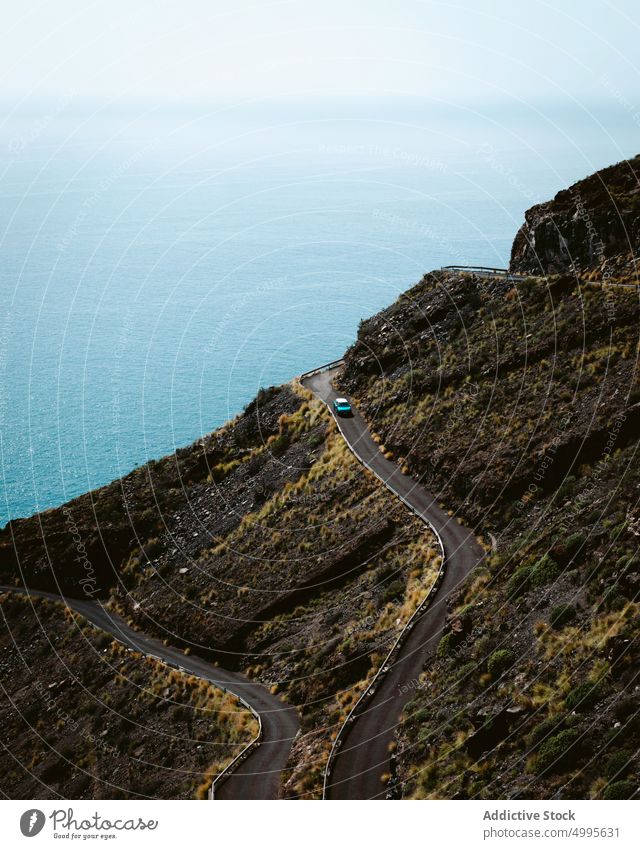 Road with car on mountain near sea drive road travel slope shore water road trip la palma canary islands spain nature breathtaking countryside curve wanderlust