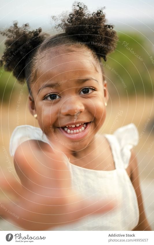 Happy African American girl in countryside smile happy weekend summer appearance portrait style black african american ethnic hair bun curly hair innocent kid