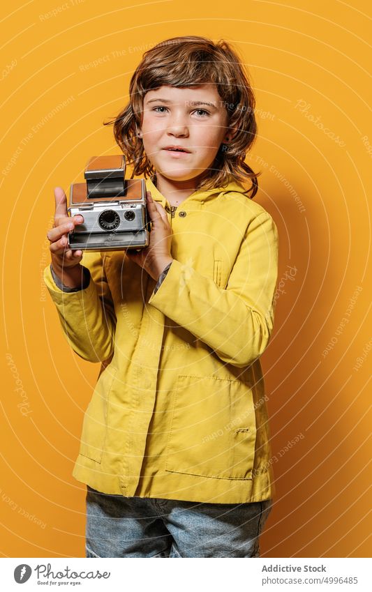 Girl taking photo on vintage camera on yellow wall in studio girl colorful take photo style photographer autumn portrait photo camera childhood lens digital