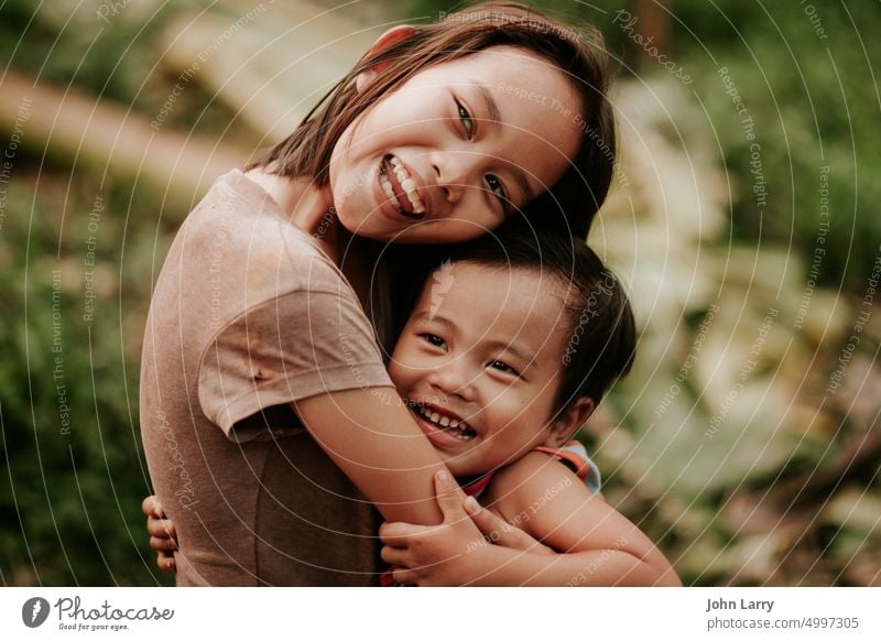 siblings Sister hug Philippines Love family emotion face young health together care single outdoors leisure mood babyhood real