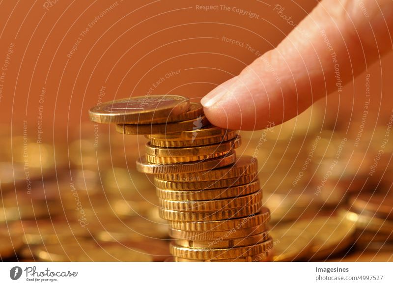 Stack of falling euro coins plummeting Euro Coins Fingers property prices insecurity housing market tip stacked Heap background concept accounting Bench banks