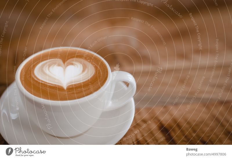 Cappuccino cup with latte art heart on wooden table. cappuccino coffee tabletop cappuccino cup aroma barista beverage beverages blur board brown brown tone cafe