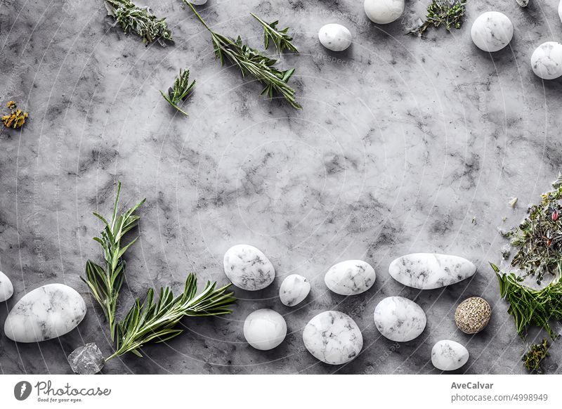 leaves on a marble background.Flat lay, top view, copy space. Natural organic product, beauty and spa concept.massage stones, essential oils and sea salt