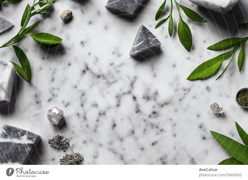 leaves on a marble background.Flat lay, top view, copy space. Natural organic product, beauty and spa concept.massage stones, essential oils and sea salt