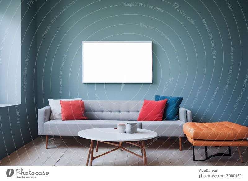 Blank picture frames mockups on white wall. White living room design. View of modern boho style interior with sofa.Interior and frame mockup.View of modern scandinavian style interior with chair.