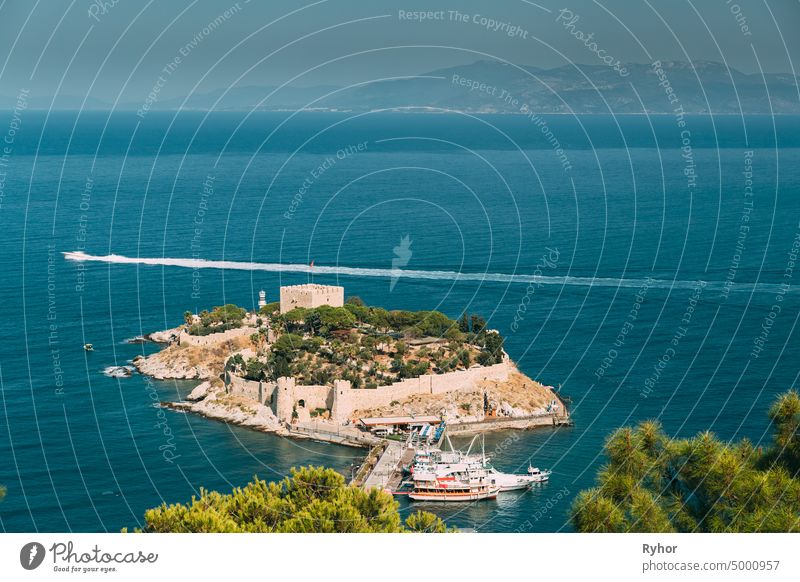 Kusadasi, Aydin Province, Turkey. Top View Of The Pigeon Island. Old 14th-15th Century Fortress On Guvercin Adasi In The Aegean Sea. Bird Island ancient