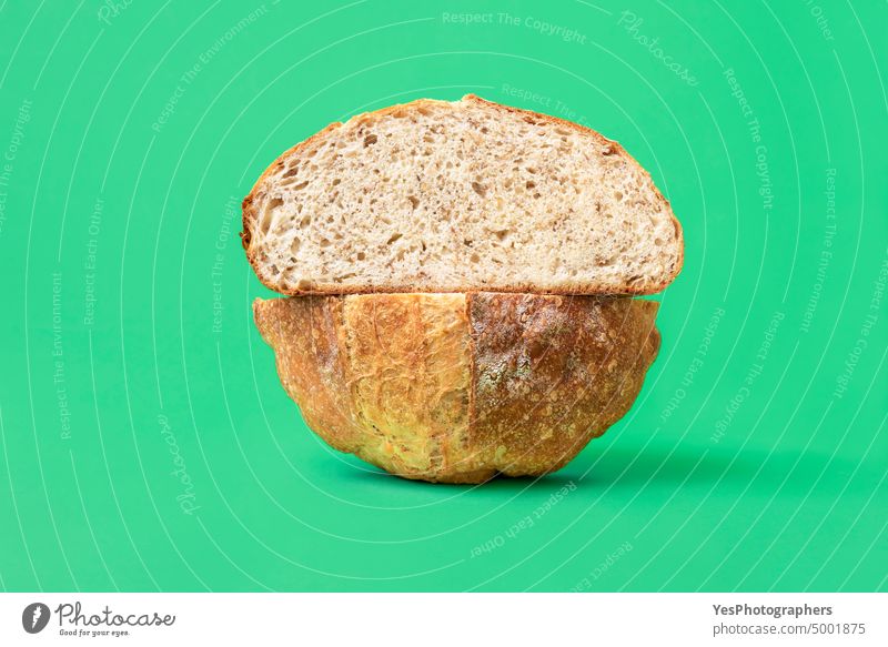 Sliced bread on a green background. White bread with sesame seeds. artisan baked bakery bright brown carbs close-up color crust cuisine delicious food fresh