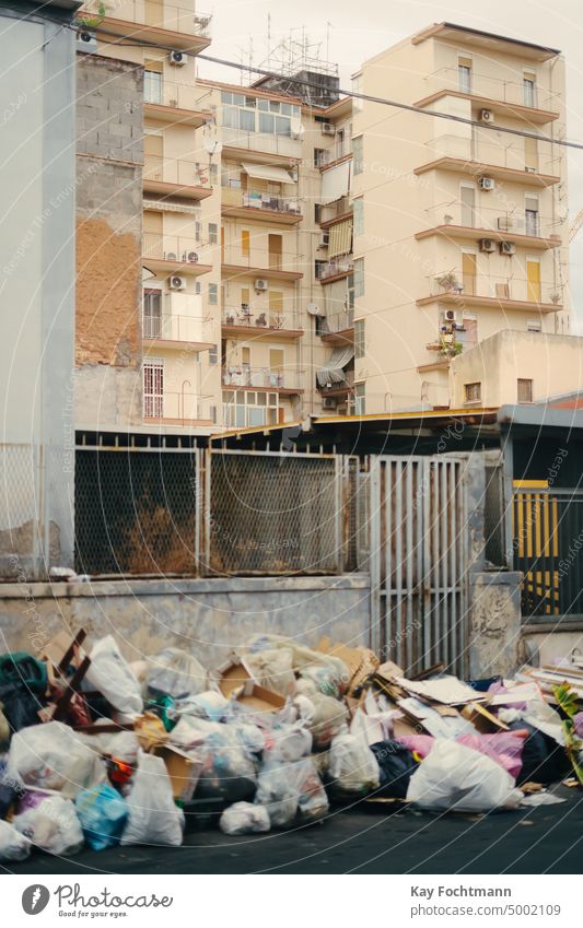 Garbage bags pile up on a residential street in Catania, Italy architecture building catania city dirt dirty disposal dump ecology environment environmental