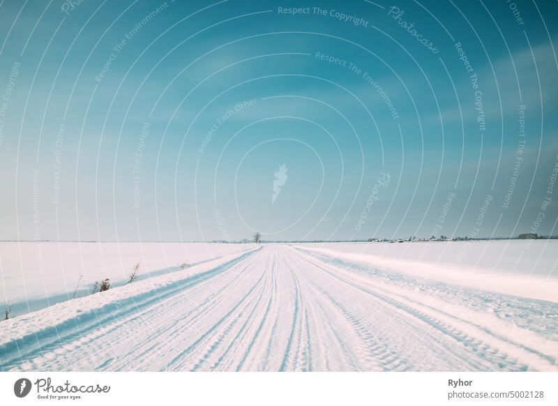Snow-covered Countryside Road In Winter Sunny Day beautiful blue cold copy space country road countryside field frost frozen landscape meadow nature nobody