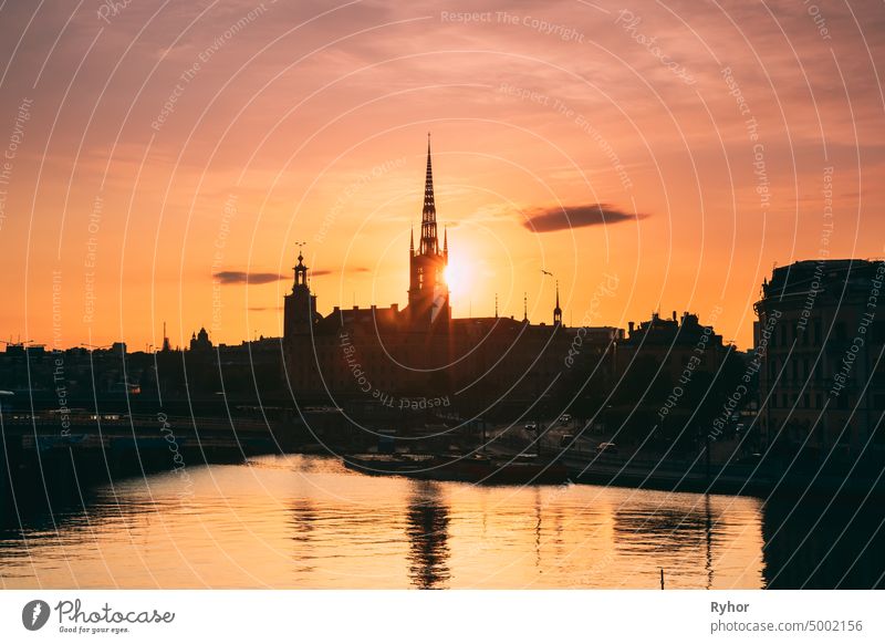Stockholm, Sweden. Sunset Sun Shine Through Dark Silhouette Of Riddarholm Church In Stockholm Skyline. Scenic View Of Gamla Stan Old Town In Dramatic Sunshine Sunlight. Famous Popular Destination Scenic