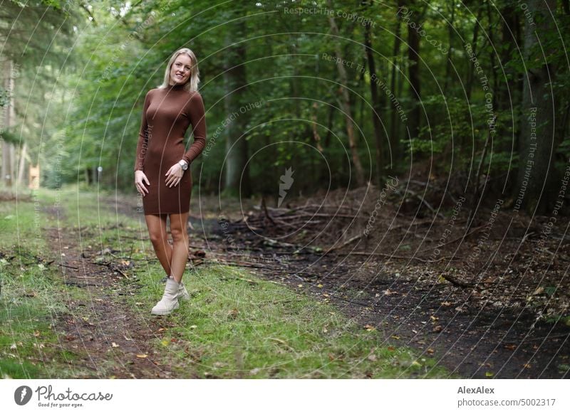 Young blonde woman standing in forest smiling happily to camera Young woman Woman Blonde Feminine pretty fortunate Youth (Young adults) portrait Adults