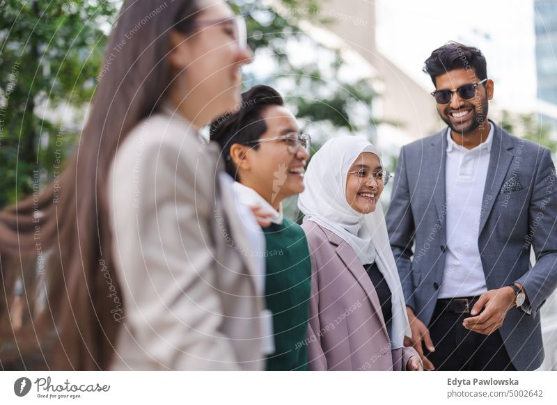 Multi-ethnic group of young business people outdoors in the city Multiracial Group team diversity teamwork muslim office real people adult student positive