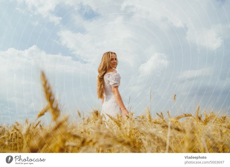 Summer woman portrait in rural countryside in wheat field rustic nature dress fashion lifestyle calm artistic summer female alone young freedom beautiful