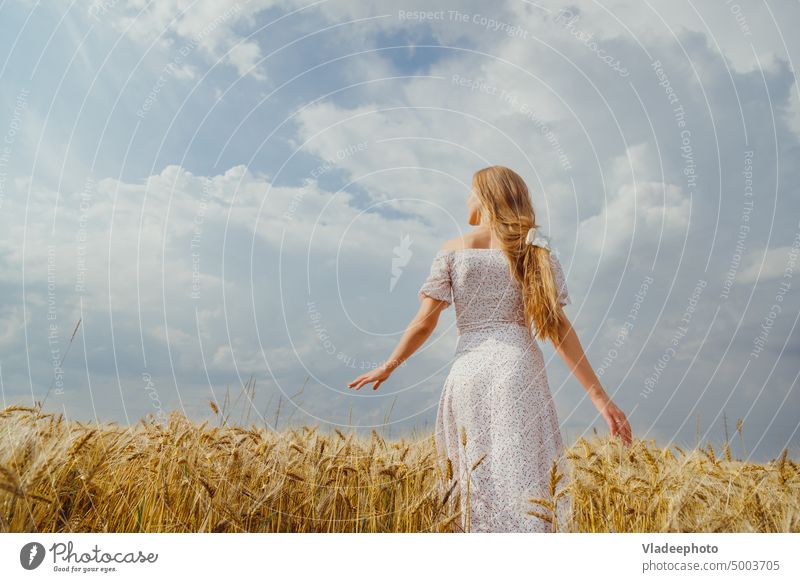 Summer woman portrait in rural countryside in wheat field back rustic rye nature dress fashion lifestyle calm artistic summer beauty alone mood female young