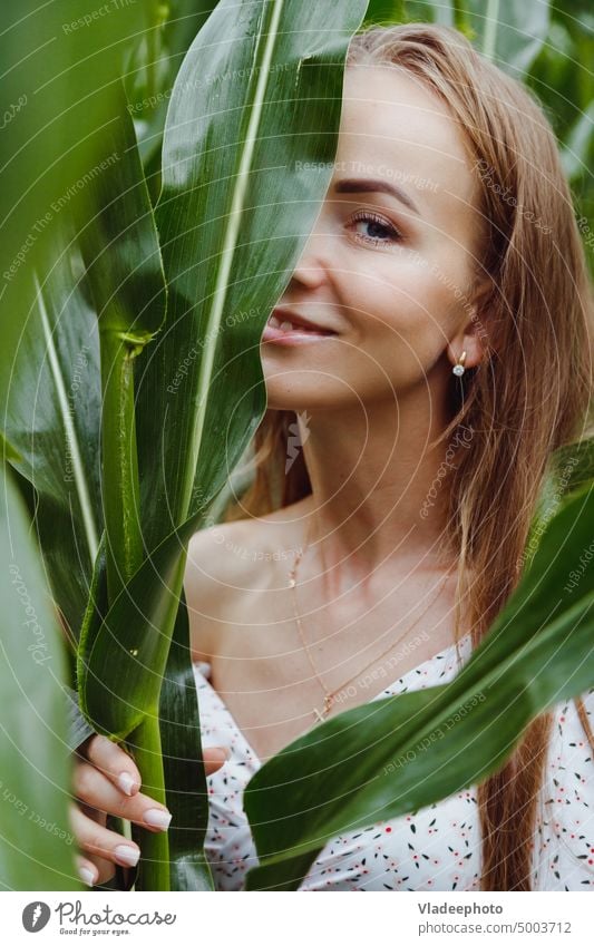Beauty woman face. Woman model with natural makeup and healthy skin behind green leaf plant Nature Beauty & Beauty Face Skin Pure naturally portrait Model Girl