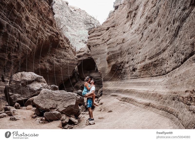 Young couple on their honeymoon young heterosexual woman blue barranco vacas cave volcanic spain copy space geological travel geology erosion canyon nature
