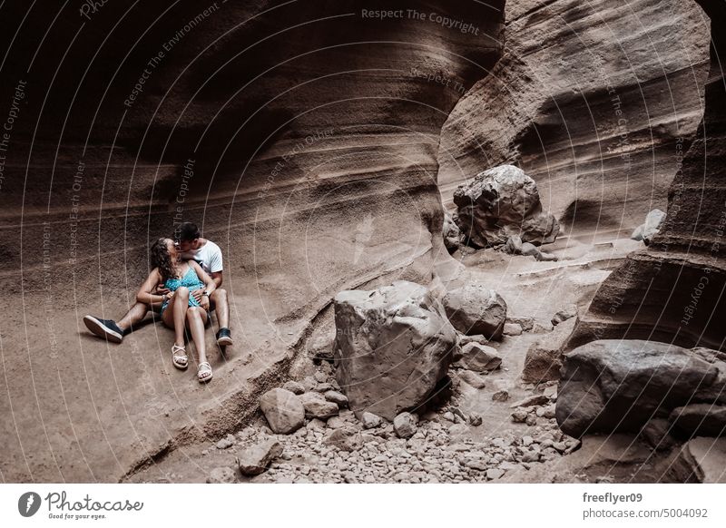 Young couple on their honeymoon young heterosexual woman blue barranco vacas cave volcanic spain copy space geological travel geology erosion canyon nature