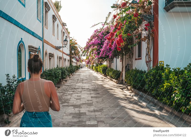 Young tourist walking by a pintoresque village in Gran Canaria canary attractive city urban visit historic old small cosy town european street banner colonial