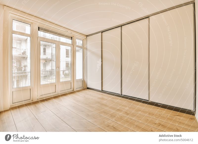 Empty room of a modern flat apartment indoor interior floor parquet empty home new house wall contemporary estate property residential window light white design