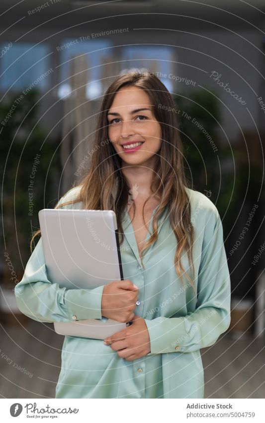 Cheerful female freelancer with tablet woman home smile room happy break evening portrait young friendly gadget cheerful device positive occupation dim dark