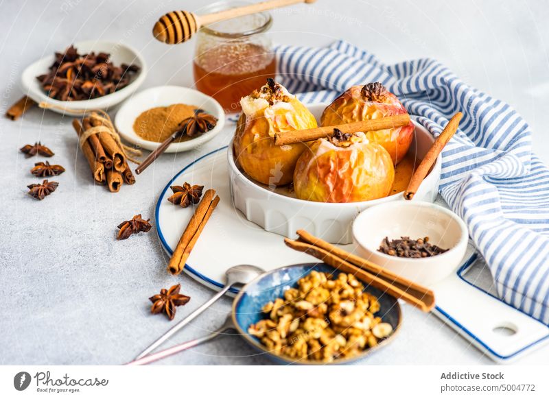 Autumnal dessert with apples and walnuts anise star autumn autumnal background baked blue ceramic cinnamon concrete diet eat eating fall falltime food harvest