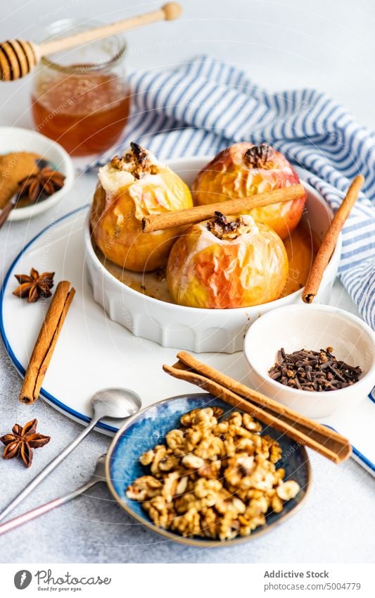 Autumnal dessert with apples and walnuts anise star autumn autumnal background baked blue ceramic cinnamon concrete diet eat eating fall falltime food harvest