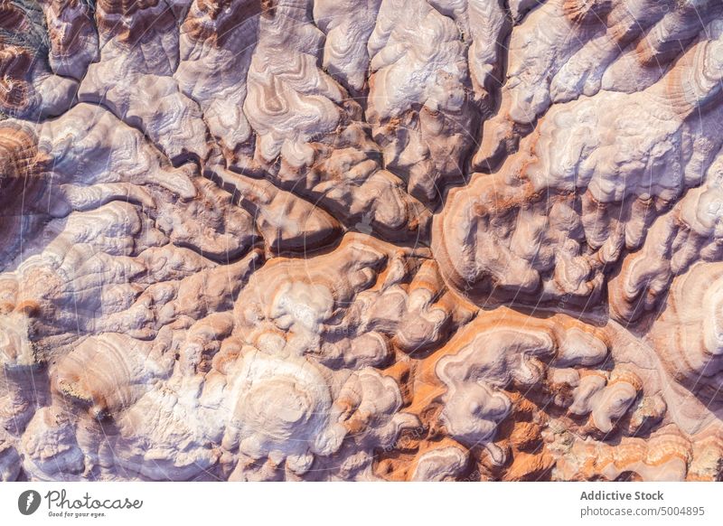 Textured background of uneven surface of sandstone cliffs in sunlight nature landscape rocky texture abstract rough formation erosion scenery terrain mountain