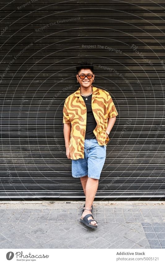 Happy non binary guy in stylish outfit man lgbt smile trendy street style fashion grunge cool summer colorful filipino asian personality bright city confident