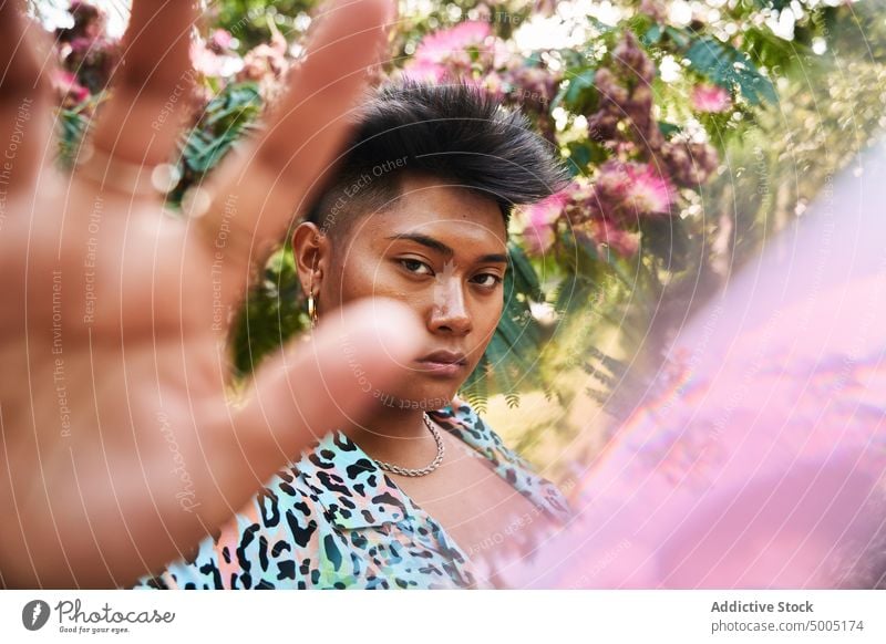 Filipino transgender woman gesturing stop gesture garden tree bloom lgbt non binary prohibit flower ethnic asian filipino appearance foliage queer blossom