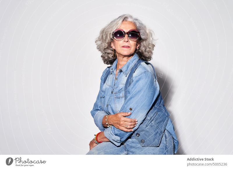 Stylish senior woman in denim clothes style appearance pensioner outfit portrait casual female elderly aged sunglasses apparel modern accessory gray hair retire