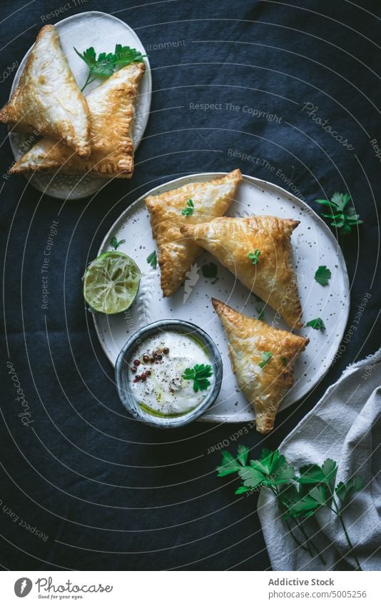 Puff pastry triangles with cream cheese and lime puff sauce drapery bowl plate serve homemade tasty dish yummy culinary food gourmet fresh baked flavor