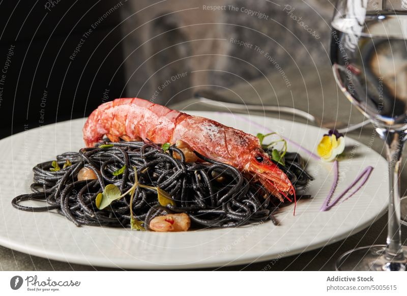 Spaghetti Neri dish on plate spaghetti neri prawn pasta seafood lunch restaurant sprout squid ink serve tradition cuisine portion delicious tasty gourmet yummy