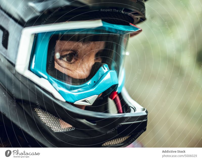 Woman in helmet and sport glasses in forest woman active sportswoman security nature adrenaline safety young extreme tree rider equipment lifestyle speed female