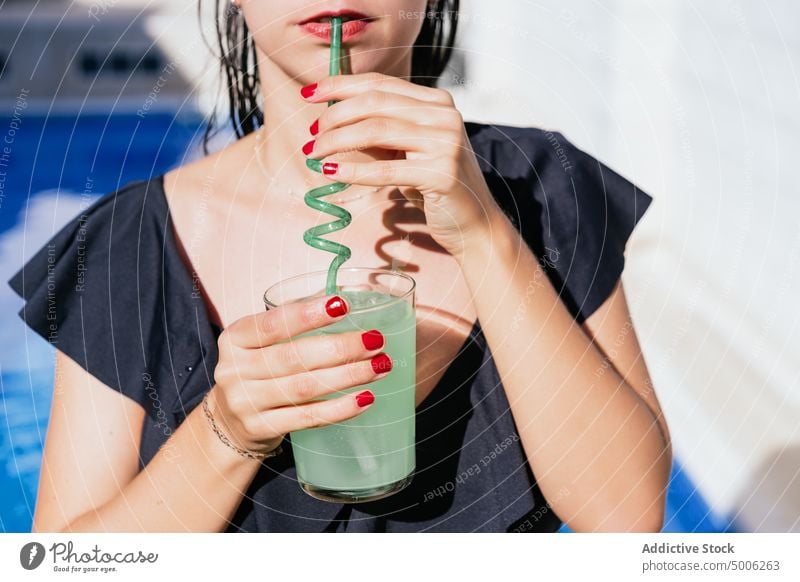 Woman enjoying cold drink on poolside woman refresh glass straw summer tropical female green beverage summertime refreshment chill spiral resort vacation relax