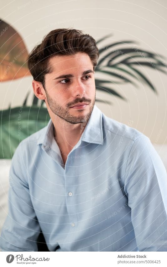 Young man in casual shirt looking away young confident style trendy serious modern beard success hairstyle male handsome appearance calm elegant guy